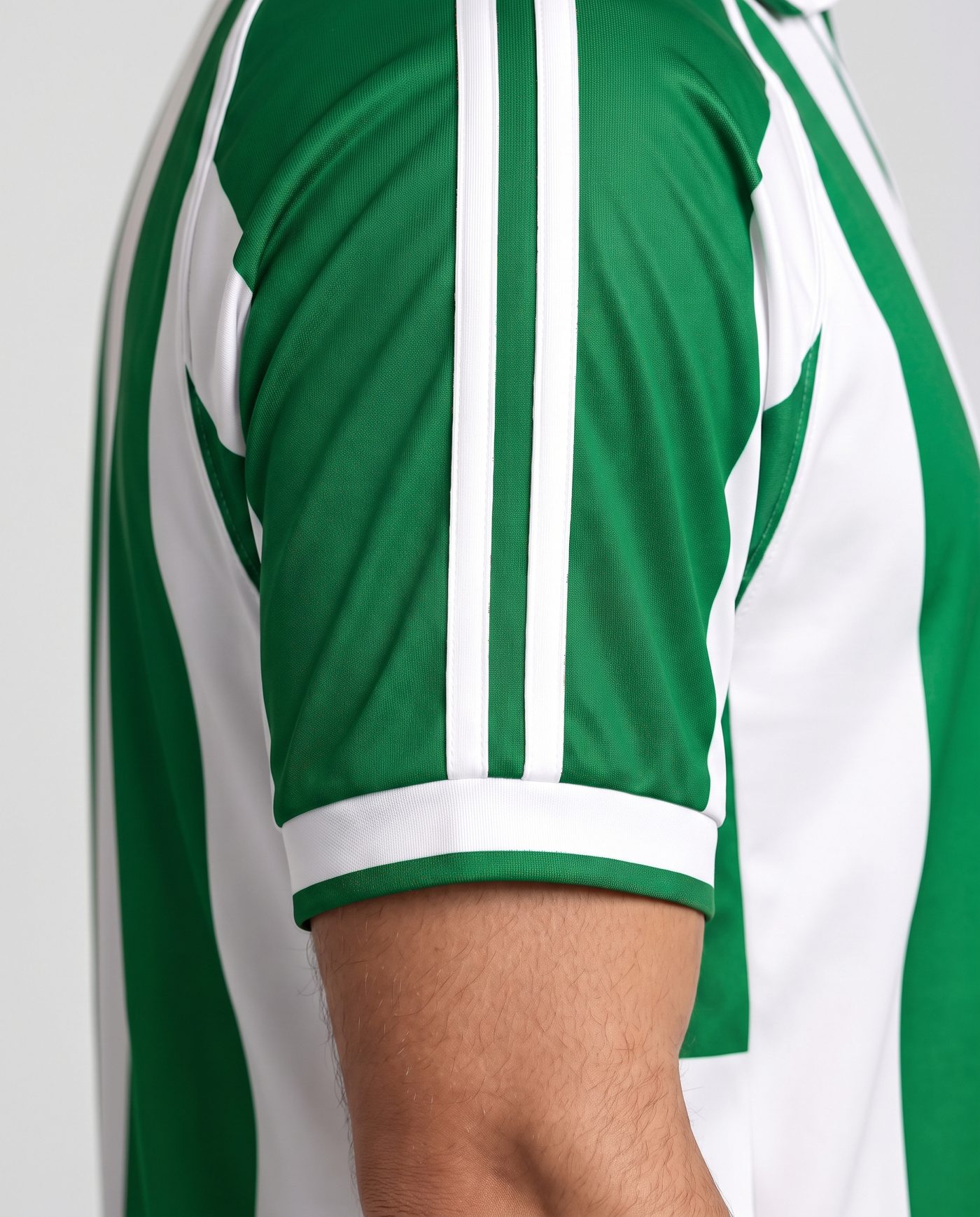 Close-up of the right sleeve of the green and white Denilson 16 shirt