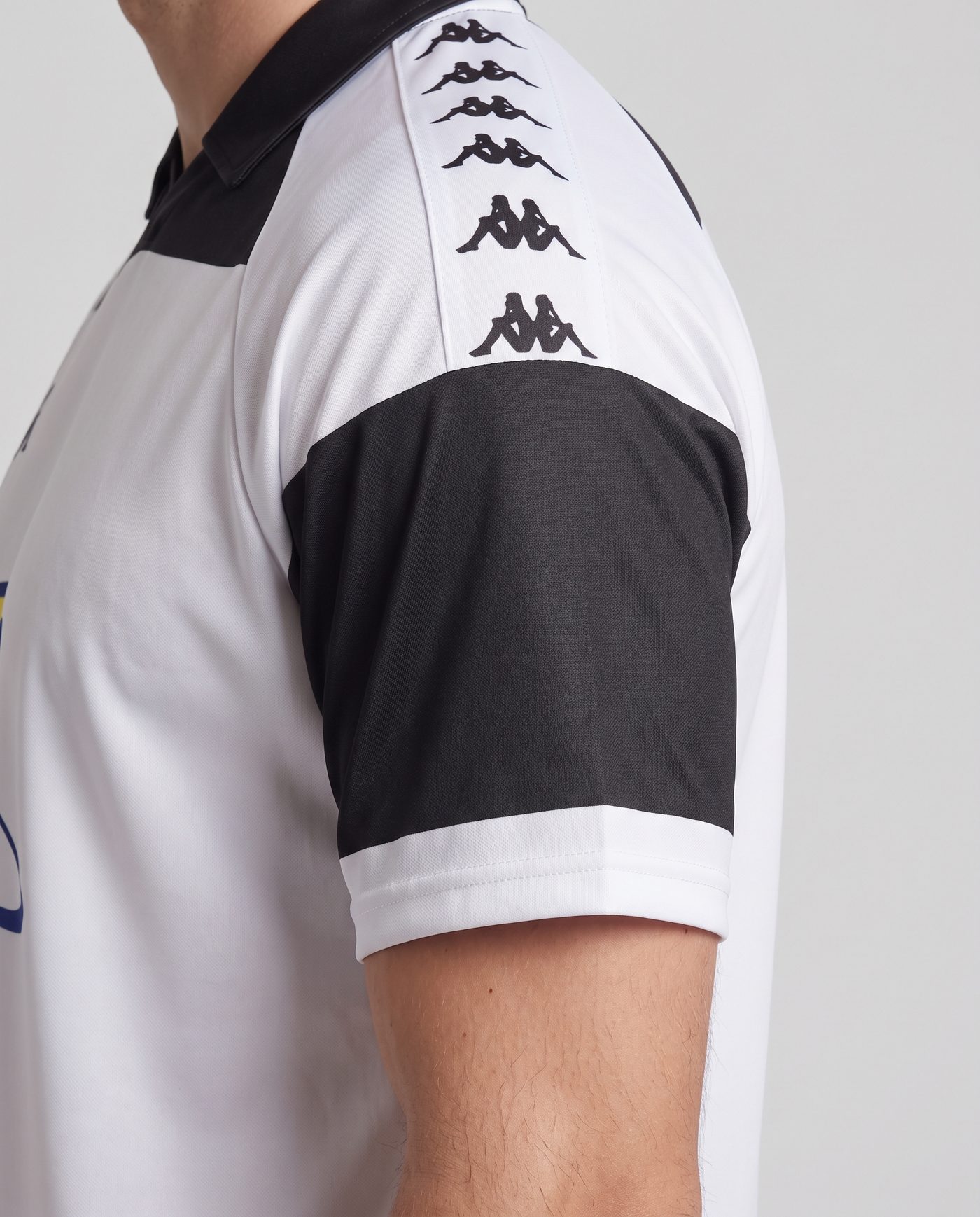 Close-up of the left sleeve, white with the black panel and the Kappa tape, of the Dobrovolski 10 shirt