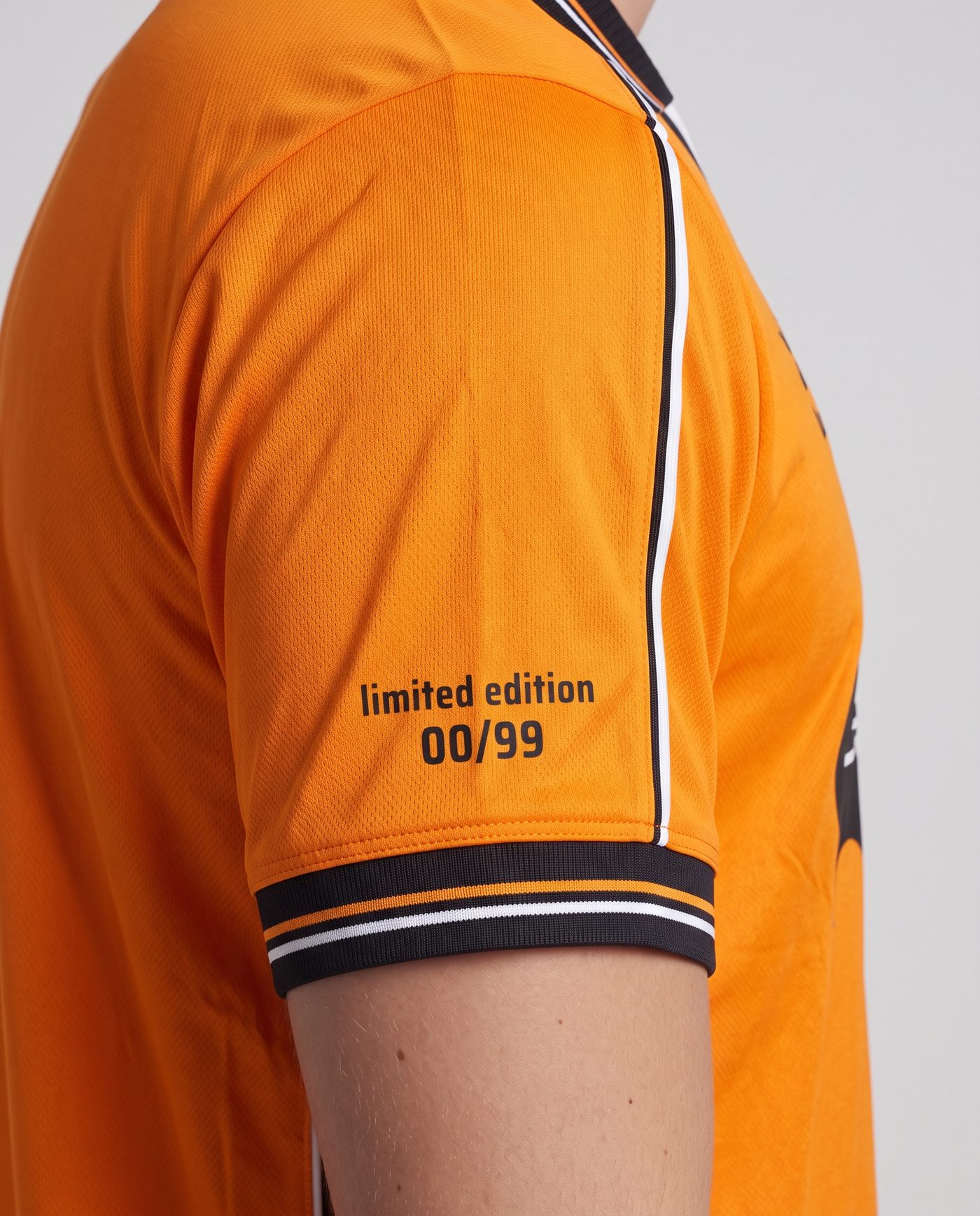 Close-up of the right sleeve of the orange Mendieta 6 shirt