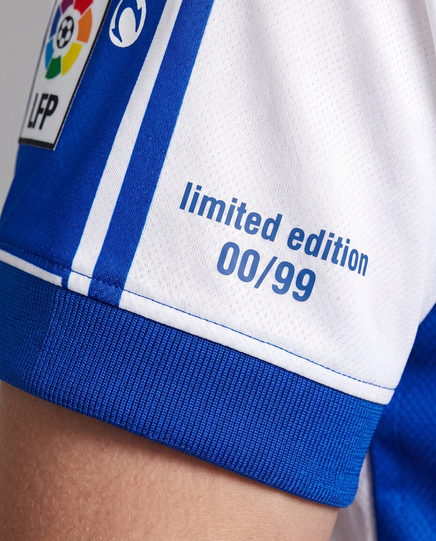 Close-up of the limited edition numbering on the sleeve of the Tamudo 23 shirt